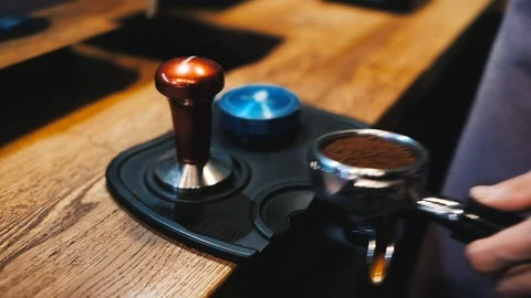 Barista presses coffee on the table and picks up Stock Footage 124148646