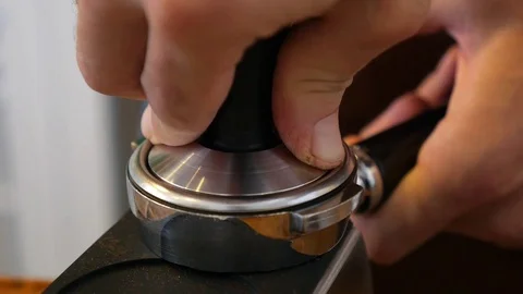Barista Presses Ground Coffee Using Tamper. Close-up Video stock 75045144