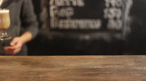 Barista putting cup of coffee down on counter in a cafe Stock Footage 59822860