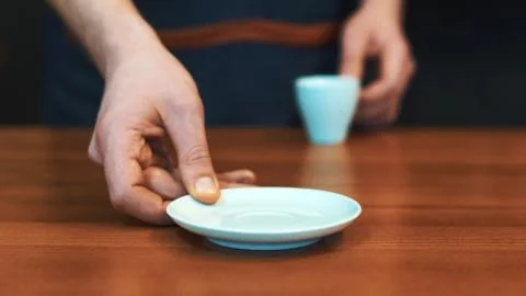Barista serving a cup of coffee to camera Stock Photos