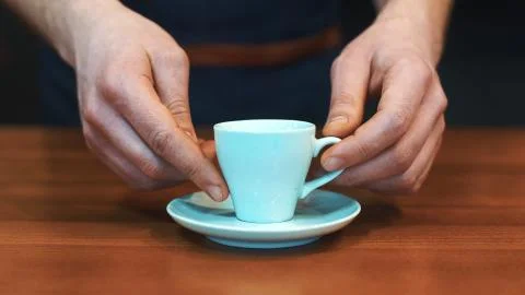 Barista serving a cup of coffee to camera Stock Photos