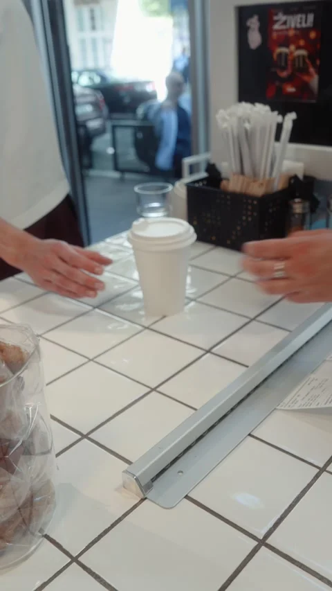 Barista Serving Fresh Coffee to Customer at Cafe Counter Stock Footage 339085791