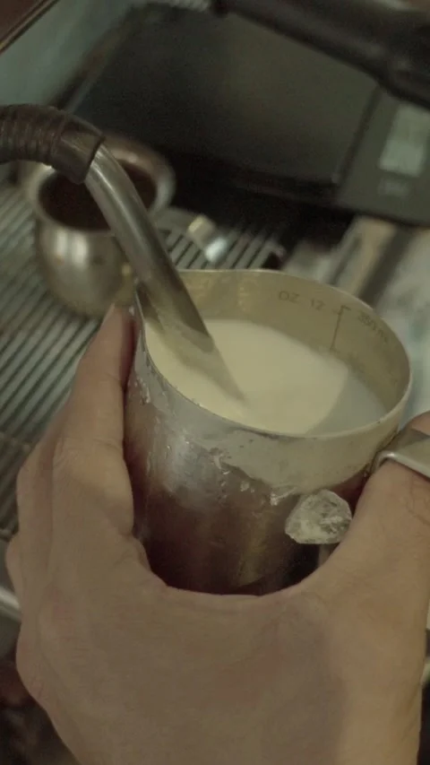 Barista Skillfully Steaming Milk for Perfect Coffee Creations Stock Footage 331331579