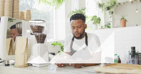 Barista standing behind cafe counter tapping tablet, tracking sales with Stock Footage 331593359