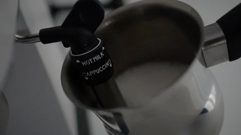 Barista steaming milk for a latte or cappuccino Stock Footage 101445643