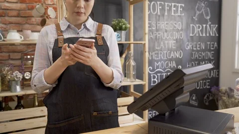 Barista talking on mobile phone with customer Video stock 127214955