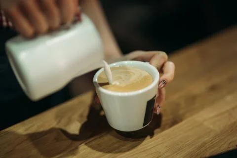 Barista using a coffee machine in cafe 스톡 사진