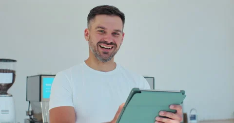 Barista using digital tablet in cafe. The male staff are checking the products Stock Footage 203898543