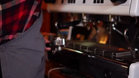 Barista working with modern espresso machine changing coffee filter to make Stock Footage 104514282