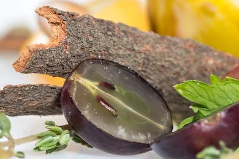 The Bark of cinnamon with half grape Stock Photos