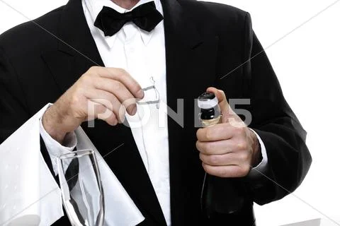 Barkeeper opening bottle of sparkling wine Stock Photos