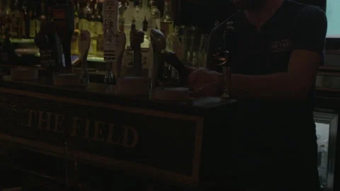 Barkeeper Pouring Pint of Beer at Pub Tap Counter Stock Footage 343950595