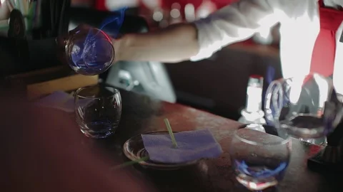 Barkeeper preparing alcoholic cocktail with a flame, bar counter. slow motion Stock Footage 105093707
