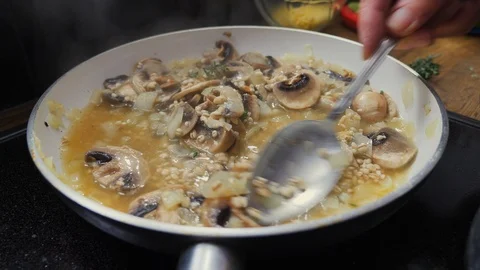 Barley risotto slowly cooking down in a pan Video stock 88110974