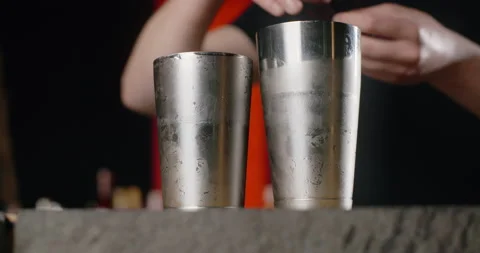 Barman adds fresh red basil to the opened shaker, making of the cocktail with Stock Footage 156330356