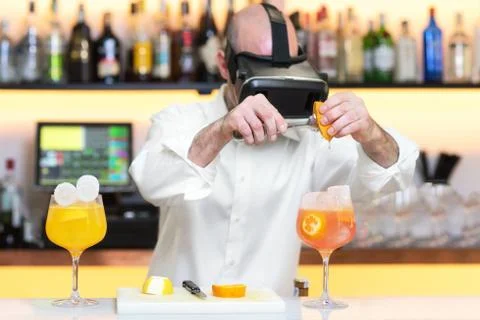 Barman apprentice preparing cocktail with virtual reality teacher. Apprentice Stock Photos