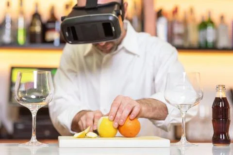 Barman apprentice preparing cocktail with virtual reality teacher. Apprentice Stock Photos