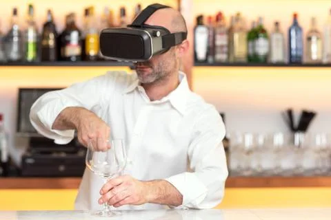Barman apprentice training serving cocktail with virtual reality teacher Stock Photos