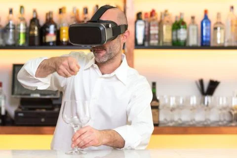 Barman apprentice training serving cocktail with virtual reality teacher Stock Photos