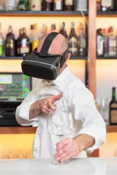 Barman apprentice training serving cocktail with virtual reality teacher Stock Photos