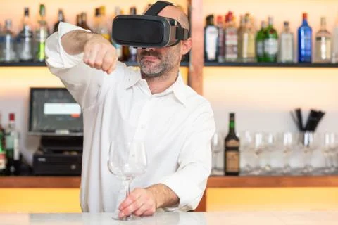 Barman apprentice training serving cocktail with virtual reality teacher Stock Photos