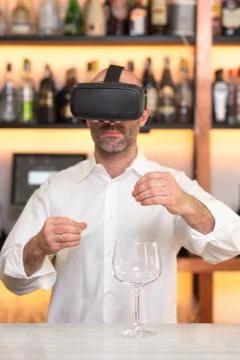 Barman apprentice training serving cocktail with virtual reality teacher Stock Photos