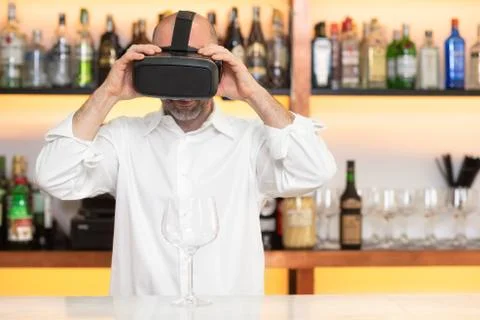 Barman apprentice training serving cocktail with virtual reality teacher Stock Photos