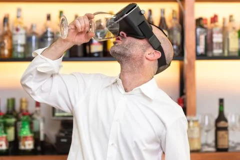 Barman apprentice training serving cocktail with virtual reality teacher Stock Photos