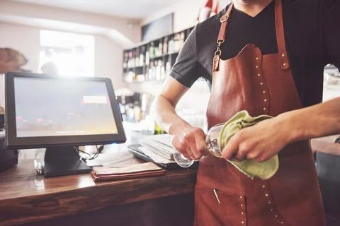 Barman in bar interior making alcohol cocktail. Professional bartender pour.. Stock Photos