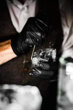 Barman breaking ice with pick Foto stock