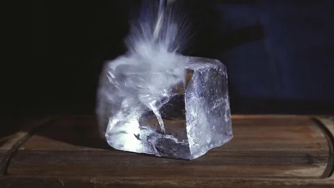 Barman chopping ice using a special knife. ?hunks of ice flying around Stock Footage 83786134