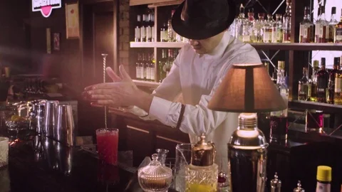 Barman in a hat prepares a cocktail in big glass close-up slow motion. Stock Footage 76720697
