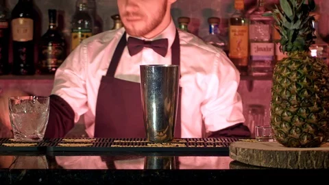 Barman makes cocktail at red nightclub Stock Footage