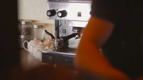 The barman makes coffee in the coffee machine at the bar. Stock Footage 98477167