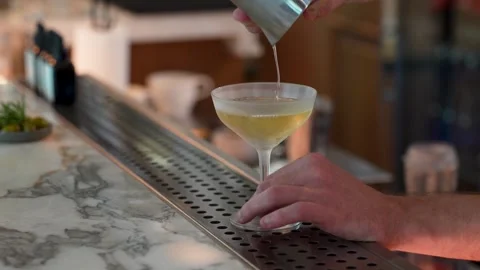 Barman making cocktail. Bartender is making cocktail at bar counter, close-up Stock Footage 282713675