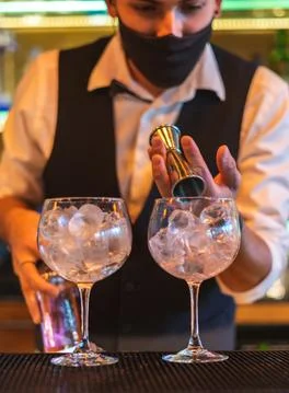 Barman making cocktail at night club Stock Photos