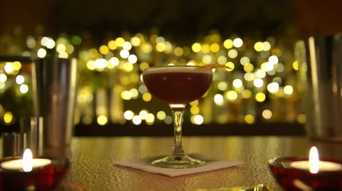 Barman misologist presents cocktail to camera in moody bar Stock Footage 47678649