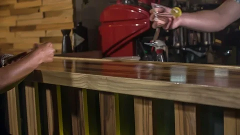 Barman is offering a drink to the lady Stock Footage 112201026