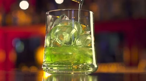 Barman pouring coctail on black table with reflection Stock Footage 55404909