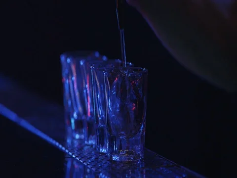 Barman pouring drinks into glasses on bar table. Lounge bar atmosphere. Stock Footage 70758628