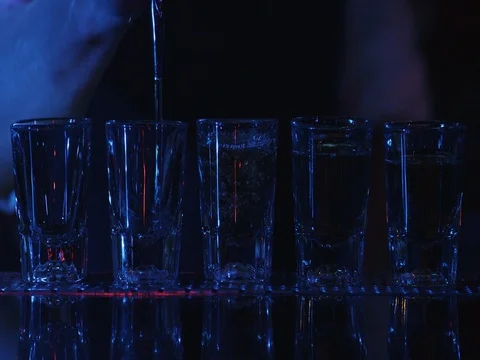 Barman pouring drinks into glasses on bar table. Lounge bar atmosphere. Stock Footage 70759636
