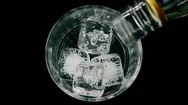 Barman Pouring Whiskey With Ice Cubes In The Glass On Wood Table, View Top Stock Footage