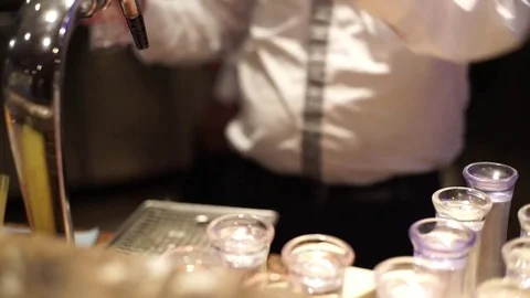 The barman pours a glass of beer. Stock Footage 74378258