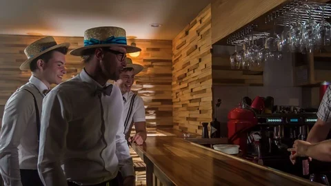 Barman prepares drinks for three guys Stock Footage 112192646