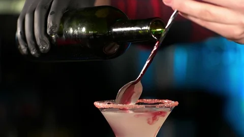 Barman preparing and pouring red cocktail. Stock Footage 74964439
