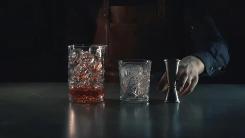 The barman is preparing a summer, refreshing alcohol cocktail Negroni Stock Footage 87384750