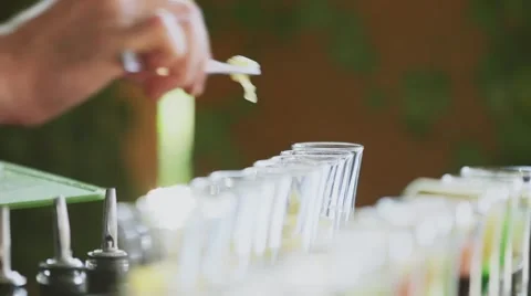 Barman puting lemon into glasses Video stock 56377706