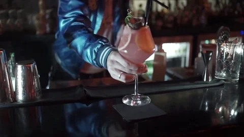 The barman puts on the table A cocktail with lime and mint in the glass Stock Footage 76748291