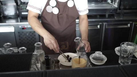 The barman puts on the table A cocktail with lime and mint in the glass Stock Footage 78221746