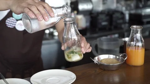 The barman puts on the table A cocktail with lime and mint in the glass Stock Footage 78412732